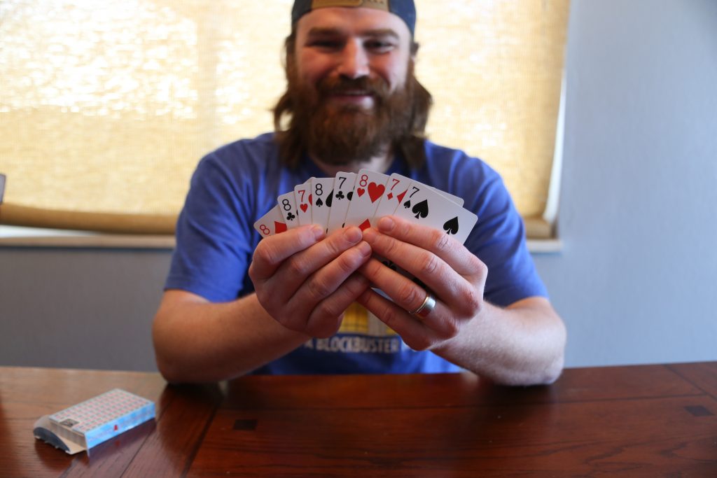 a man holding playing cards